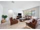 Cozy living room featuring tile floors, leather furniture, and a decorative fireplace at 2167 W Ethan Ct, San Tan Valley, AZ 85144