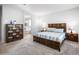 Comfortable main bedroom featuring carpet, a wooden furniture set, and calm natural lighting at 2167 W Ethan Ct, San Tan Valley, AZ 85144