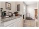 Functional pantry area with granite countertops, white cabinets, and adjacent workout area at 2167 W Ethan Ct, San Tan Valley, AZ 85144