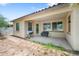 Cozy covered patio space with barbeque and bench for outdoor relaxation and entertainment at 2167 W Ethan Ct, San Tan Valley, AZ 85144