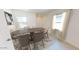 Elegant dining room with modern furniture, neutral color palette, and large windows at 24215 W Hidalgo Ave, Buckeye, AZ 85326
