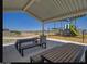 Shaded community picnic area with tables and benches, perfect for outdoor gatherings by the playground at 24215 W Hidalgo Ave, Buckeye, AZ 85326