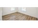 Bright bedroom features wood-look floors, white walls, and natural light from two windows at 25958 W Muirfield Dr, Morristown, AZ 85342