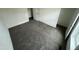 Bedroom with plush gray carpet, window, and freshly painted neutral walls provide a comfortable canvas at 25958 W Muirfield Dr, Morristown, AZ 85342
