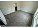 A bright bedroom features plush carpeting and an ensuite bathroom for added convenience at 25958 W Muirfield Dr, Morristown, AZ 85342