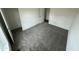 Spacious bedroom featuring neutral carpet, white trim, and a closet for functional comfort at 25958 W Muirfield Dr, Morristown, AZ 85342