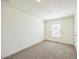 Bedroom with plush carpeting, white walls, window, and overhead lighting at 25958 W Muirfield Dr, Morristown, AZ 85342