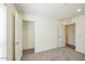 Carpeted bedroom with closet, neutral paint, and ample natural light at 25958 W Muirfield Dr, Morristown, AZ 85342