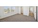 Bright bedroom with plush carpeting, sunlit windows, and freshly painted white walls at 25958 W Muirfield Dr, Morristown, AZ 85342