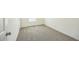 Sunlit bedroom with carpet, white walls, white trim, and an access door at 25958 W Muirfield Dr, Morristown, AZ 85342