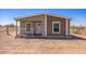 Charming single-story home with a welcoming front entrance and desert landscape at 25958 W Muirfield Dr, Morristown, AZ 85342