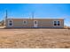 Front view of single-story house in a desert setting with clear blue sky at 25958 W Muirfield Dr, Morristown, AZ 85342