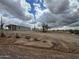 Spacious single-story home situated on a large lot with rocks in desert landscaping at 25958 W Muirfield Dr, Morristown, AZ 85342