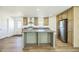 Well-lit kitchen with ample counter space, a center island, and modern stainless steel appliances at 25958 W Muirfield Dr, Morristown, AZ 85342