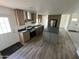 An open concept kitchen with wood cabinets, stainless steel appliances, and wood floor at 25958 W Muirfield Dr, Morristown, AZ 85342
