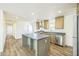 Open kitchen featuring sleek countertops, a center island, and stainless steel appliances at 25958 W Muirfield Dr, Morristown, AZ 85342