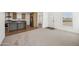 Open-concept living room and kitchen area featuring modern finishes at 25958 W Muirfield Dr, Morristown, AZ 85342
