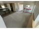 Spacious living room with access to the kitchen featuring dark countertops at 25958 W Muirfield Dr, Morristown, AZ 85342