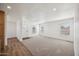 Bright living room featuring plush carpeting, fresh paint, and natural light at 25958 W Muirfield Dr, Morristown, AZ 85342