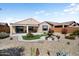 Home's backyard showcasing the manicured landscaping, fountain, and outdoor living space at 27391 W Wahalla Ln, Buckeye, AZ 85396
