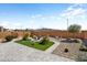 Backyard featuring desert landscaping, a fountain, and a low wall surrounding the space at 27391 W Wahalla Ln, Buckeye, AZ 85396