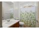 Bright bathroom featuring a vanity with a sink and a toilet with a decorative shower curtain at 27391 W Wahalla Ln, Buckeye, AZ 85396