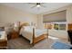 Cozy bedroom featuring soft natural light, a window with a garden view, and neutral decor at 27391 W Wahalla Ln, Buckeye, AZ 85396