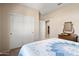 View of the bedroom featuring a closet with white doors and a mirror dresser at 27391 W Wahalla Ln, Buckeye, AZ 85396