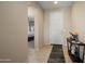Inviting foyer features tile flooring and a glimpse into the bedroom, offering a peek into the layout and flow at 27391 W Wahalla Ln, Buckeye, AZ 85396