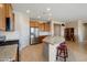 Bright kitchen featuring granite countertops, stainless steel appliances, island with barstool seating, and ample cabinet space at 27391 W Wahalla Ln, Buckeye, AZ 85396