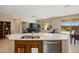 Open-concept kitchen featuring granite countertops, stainless steel appliances, and seamless flow into the living area at 27391 W Wahalla Ln, Buckeye, AZ 85396