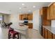 Well-lit kitchen showcases a large island, granite countertops, stainless appliances, and ample cabinet space at 27391 W Wahalla Ln, Buckeye, AZ 85396