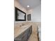 Updated bathroom features stone countertops, dark wood cabinets, framed mirror, and decorative tiled backsplash at 2808 E Lupine Ave, Phoenix, AZ 85028