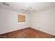 Bright bedroom featuring hardwood floors, neutral walls, and a ceiling fan at 2808 E Lupine Ave, Phoenix, AZ 85028