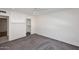 Spacious bedroom with soft carpet and a closet featuring a nearby door at 2808 E Lupine Ave, Phoenix, AZ 85028
