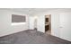 A bright bedroom with gray carpet, a walk-in closet, and an en-suite bathroom with a modern vanity at 2808 E Lupine Ave, Phoenix, AZ 85028