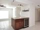 Breakfast bar with wine fridge, granite counters, storage cabinets, and pendant lighting at 2808 E Lupine Ave, Phoenix, AZ 85028