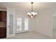 Bright dining area featuring tile floors, classic chandelier and a door to the backyard at 2808 E Lupine Ave, Phoenix, AZ 85028