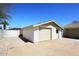 Detached garage with light trim features a convenient side door and spacious driveway at 2808 E Lupine Ave, Phoenix, AZ 85028