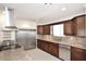 Modern kitchen with stainless steel appliances, granite countertops, and dark wood cabinets at 2808 E Lupine Ave, Phoenix, AZ 85028