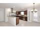 Eat-in kitchen with stainless steel appliances, granite countertops, and dark wood cabinets at 2808 E Lupine Ave, Phoenix, AZ 85028
