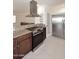 Kitchen with stainless appliances, granite counters, and eat-in bar area open to living room at 2808 E Lupine Ave, Phoenix, AZ 85028