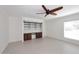 Bright living room featuring tile floors, built-in shelving, and a ceiling fan at 2808 E Lupine Ave, Phoenix, AZ 85028