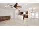 Spacious living room with tile floors, ceiling fan, and wet bar, open to the kitchen at 2808 E Lupine Ave, Phoenix, AZ 85028