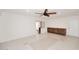 Bright living room with tile flooring and a ceiling fan, featuring a built-in cabinet along one wall at 2808 E Lupine Ave, Phoenix, AZ 85028
