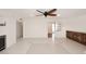 Open living area with tile flooring, ceiling fan, and views of the kitchen and a built-in cabinet at 2808 E Lupine Ave, Phoenix, AZ 85028