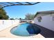 This backyard pool view features tanning deck and privacy fence at 2808 E Lupine Ave, Phoenix, AZ 85028