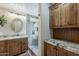 Bathroom featuring double sinks, granite counters, and a marble shower at 29322 N Red Finch Dr, San Tan Valley, AZ 85143