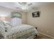 Cozy bedroom with ceiling fan, TV and plush bedding at 29322 N Red Finch Dr, San Tan Valley, AZ 85143