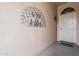 Front porch view featuring a decorative metal rooster art piece and a secured front door at 29322 N Red Finch Dr, San Tan Valley, AZ 85143